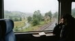 © Natalia - slow regional train journey window view Woman looking out train window at rainy countryside landscape