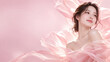 © tangmo.pa - Elegant Asian woman with radiant skin surrounded by flowing pink silk fabric