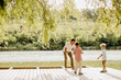 © BGStock72 - Joyful moments by the tranquil lake with family enjoying nature together