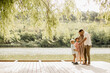 © BGStock72 - Family joy by the serene lake on a sunny afternoon