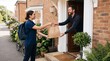 © Felippe Lopes - Delivery person hands a paper bag to a man at his front door with a bicycle nearby