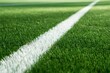 © Daria - Close-up perspective of a vibrant green sports field featuring a crisp white boundary line extending into the distance on well-maintained artificial grass surfa