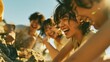 © Emi - A group of young men and women digging in the sand on the beach and laughing innocently together   Subtitle
