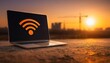 © Naufal - Laptop displaying a Wi-Fi signal icon against a sunset cityscape.
