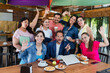 © Marcos - Group of Latino teamwork gathered together for brainstorming in cafeteria using laptop and notebook at breakfast time. young hispanic people woman and men working in Mexico Latin America