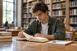 © DigitalDreamscape - Adult student reading in a quiet library