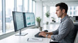 © InoStudiox - Homme tapant au clavier devant deux moniteurs dans un bureau moderne
