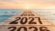 © Naeem 2.0 - Pier of wooden planks with burned 2026 2027 2028 2029 2030 numbers leading to sea horizon at sunset, new year future path concept photo for travel banner, motivation poster and presentation