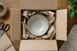 © DigitalDreamscape - Recycled paper cushioning protecting a ceramic bowl in a parcel