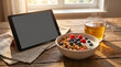 © 11 - Healthy breakfast setup with granola bowl, fresh berries, steaming tea, and digital tablet