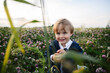 © Westend61 - A happy boy enjoys nature in a green clover field