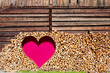 © Westend61 - A red heart decorates a firewood wall at an alpine hut in Austria