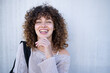 © Metadancer - Young white woman smiling outdoors in casual sweater