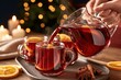 © Georgii - Hot mulled wine being poured from glass pitcher into clear mugs with orange slices, cinnamon sticks and star anise on wooden tray, warm candlelight background