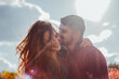 © anyatachka95 - Smiling couple embracing outdoors under sunlight