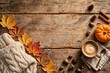 © Ahmat - Cozy autumn flat lay with maple leaves pumpkin coffee and sweater on wooden table