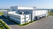 © Satriyo - Aerial view of a contemporary manufacturing facility under a clear blue sky, showcasing its expansive structure and operational readiness within an industrial park