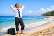 © Alexandr Efimov - Businessman enjoying a vacation at the beach with his briefcase beside him, symbolizing work-life balance.