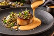 © soysuwan123 - A gourmet dish featuring a seared scallop topped with microgreens and crushed nuts, served with a creamy sauce being poured on a textured black plate.
