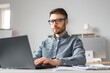 © Prostock-studio - Focused Caucasian Man In His 30s Working On Laptop At A Modern Office Desk, Engaged In Professional Tasks. Creating, Typing, Or Reviewing Documents While Surrounded By Office Equipment.