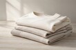© Rawpixel.com - Folded neutral knit sweaters stacked upon wooden table