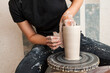 © Westend61 - Artisan shaping a clay vase on a pottery wheel in a studio