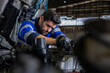 © Akarawut - Caucasian mechanic is inspecting the diesel truck engine after annual check up in the professional garage and maintenance all the filter and gear for safety driving concept