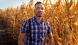 © Zoran Zeremski - Portrait of confident middle aged male farmer standing in ripe corn field looking at camera.