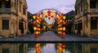 © stockimgahnaf - Beautiful colorful lanterns illuminate a narrow street in Vietnam at twilight