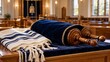 © PeachyPixels - Simchat Torah Scroll in Blue Velvet Cover with Gold Embroidery and Folded Tallit Prayer Shawl on Synagogue Table