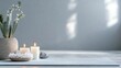 © Halyna - A serene and minimalist scene promotes relaxation and mindfulness with candles, crystals, and a cactus, emphasizing a calming atmosphere in muted gray tones