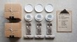 © Abdullah - 'Top-down flat lay on a light grey stone surface: stacked boxes with kraft packaging, a neat grid of white plates, cups, cutlery bundles, and napkin rolls, a clipboard with an order sheet, consistent