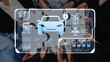© InfiniteFlow - A group of hands collaborates around a digital interface showcasing electric vehicle technology, renewable energy icons, and sustainability infographics. Raster