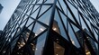 © Maryna - Close up of modern skyscraper facade with geometric glass pattern. Black steel frame forms triangular shapes on corporate office building. Contemporary urban architecture shows sleek metal structure,