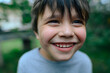 © Westend61 - A happy boy smiles at the camera outside during summer