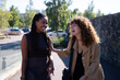 © Metadancer - Two African American and white women laughing together outdoors