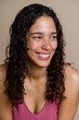© Metadancer - Smiling Hispanic woman with curly hair in beauty studio