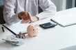 © Charlie's - Close Up Business man Hands Saving Cash in Piggy Bank to Build Personal Bank Fund and Prepare for Future Financial Goals