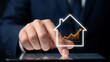 © Sanaullah - Businessman touching tablet screen showing real estate house icon with financial growth chart inside