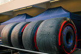 Close-up of Formula 1 racing tires stacked at a motorsport circuit, highlighting the specialized equipment used in professional Grand Prix racing.