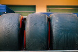 Close-up of Formula 1 racing tires stacked at a motorsport circuit, highlighting the specialized equipment used in professional Grand Prix racing.