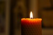© Alpaka - Burning beeswax candle flame in dark spiritual meditation setting