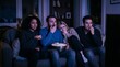 © Mauricio - Friends on a couch in a dimly lit living room watching a scary movie and reacting with fear and surprise