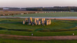 © Amazing Aerial - Aerial view of Stonehenge standing in a grassy field during the golden hour with soft morning mist over the surrounding landscape in Salisbury, England, United Kingdom.