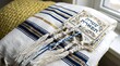 © Ashrafi - Traditional jewish tallit prayer shawl with blue and gold stripes.