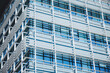 © EdNurg - Modern architecture building facade featuring glass panels, steel frames, and horizontal sunshade louvers