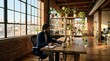 © graphicmount - Focused Black man with dreadlocks working on a laptop and taking notes in a sunlit industrial loft office with large windows overlooking a city skyline