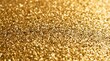 © Wanda - Close up full frame view of shimmering gold glitter forming a festive and luxurious background texture