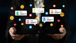 © InfiniteFlow - A businesswoman holds a tablet displaying social media comments, showcasing digital interaction and engagement in modern professional environments with colorful emojis. Ledger