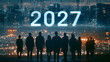 © jisan - Group of people silhouetted against a futuristic cityscape with the year 2027 prominently displayed